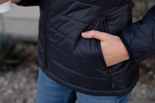 Load image into Gallery viewer, Close-up image of the full zippered pockets of our Womens Lightweight Full Zip Black Puffy Jacket
