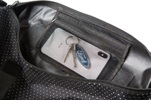 Load image into Gallery viewer, Close up detail image on the inside sipper pocket of the black duffel bag with polka dots
