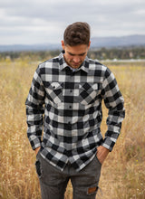 Load image into Gallery viewer, Male model wearing a grey heather and black plaid flannel shirt walking in a field
